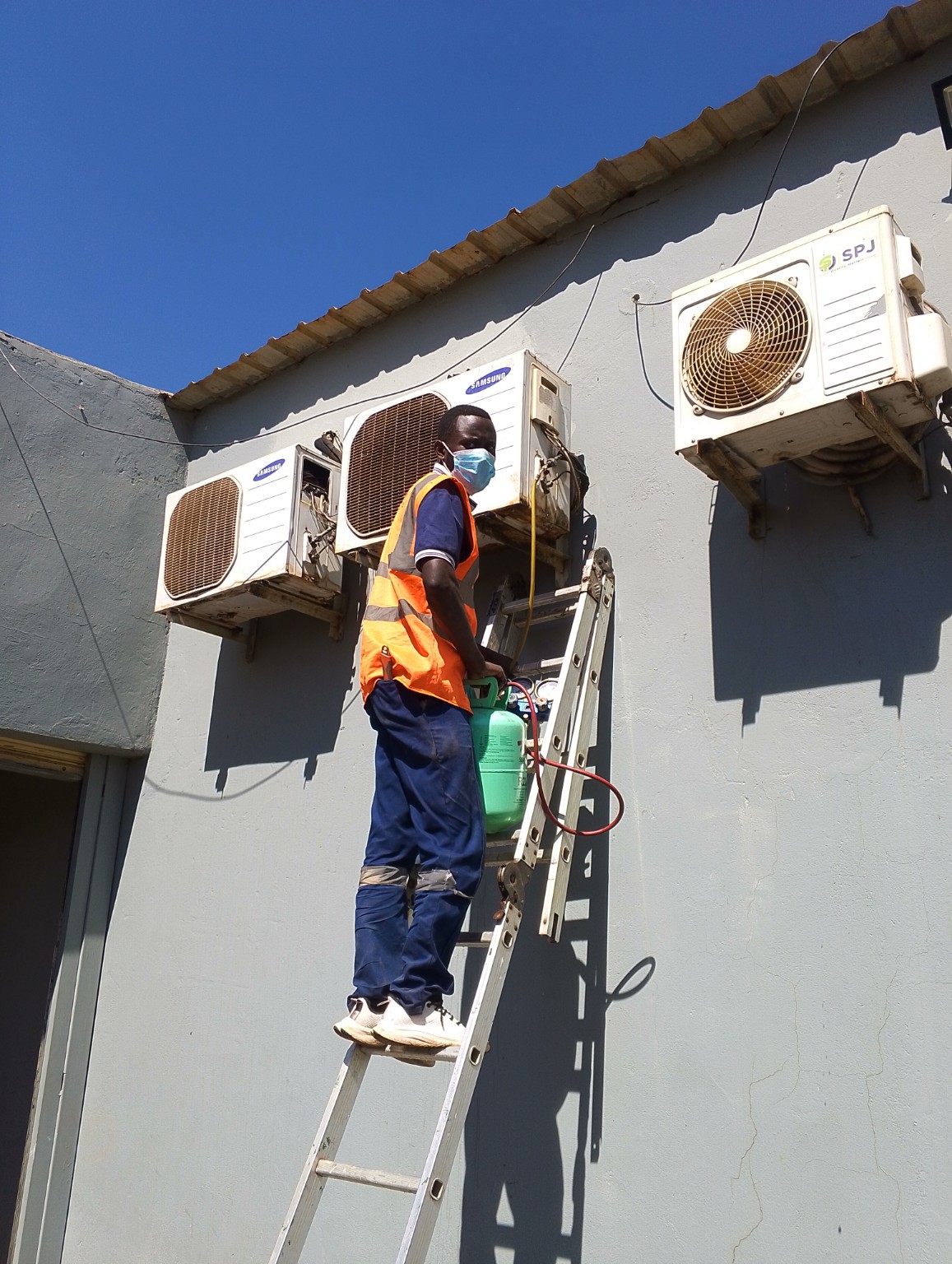 ShepTech air conditioning technician servicing outdoor units