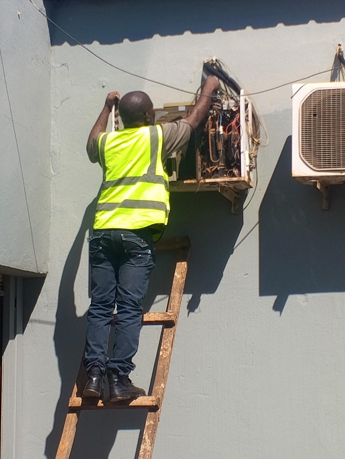 ShepTech technician repairing an air conditioning unit